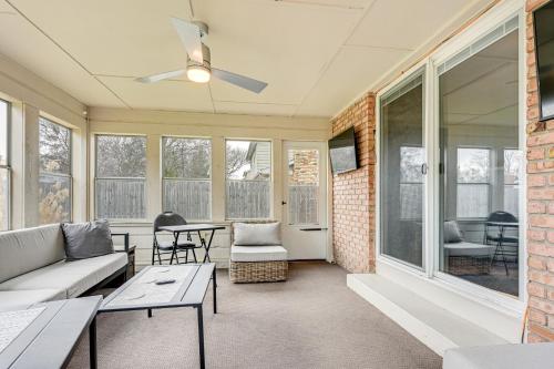 a screened in porch with a couch and a table at 3 Mi to Dtwn Saginaw Spacious and Updated Home! in Saginaw