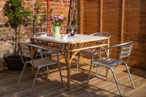 a wooden table and chairs on a patio at Half Moon House - Timeless Charm with Sea Views in Scarborough