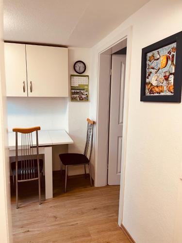 a kitchen and dining room with a table and chairs at GR Appartements in Troisdorf