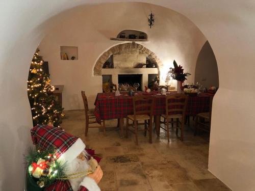 a dining room with a table and a christmas tree at Avventure tra i trulli in Martina Franca