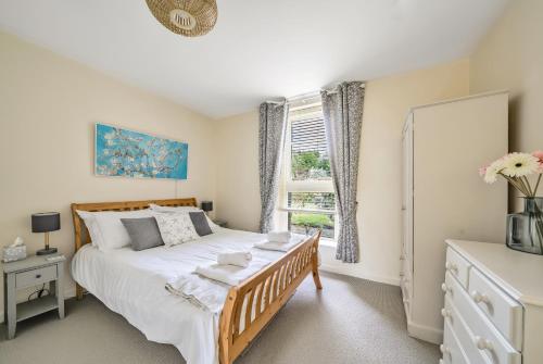 a bedroom with a large bed and a window at Coast View in Bideford