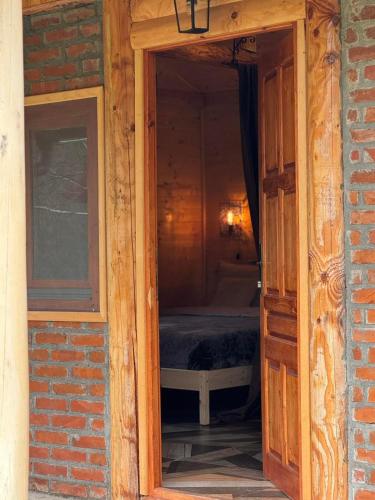 an open door to a bedroom with a bed in it at Drveni san Senović 2 in Banja