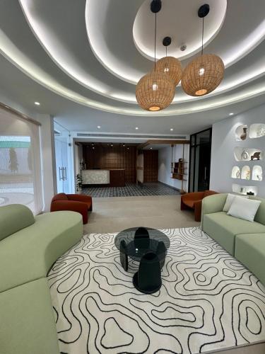 a living room with a couch and a table at Three Oceans Resort in Kanyakumari