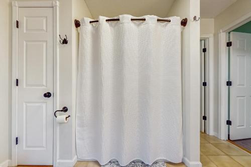 a white shower curtain in a room with two doors at Stegs Retreat in Caryville