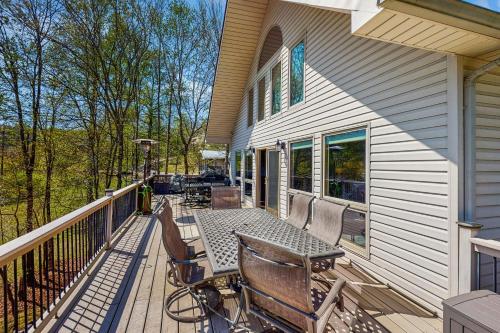 a deck with a table and chairs on a house at Stegs Retreat in Caryville
