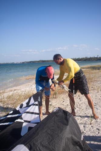 two men working on a kite on the beach at Jardim dos Afetos in Jijoca de Jericoacoara