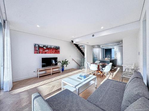a living room with a couch and a table at Modern 3BR Townhouse - Sleeps 10 - 2-Car Garage in Sydney