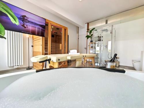 a bathroom with a large tv on the wall at Loft für bis zu 12, Whirlpool, Infrarotsauna, Arcade-Spiele, Tischfußball, Wii in Nürnberg