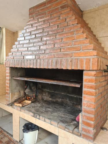 a brick oven in a room with a brick wall at Casa Al pie del Cerro in Yerba Buena