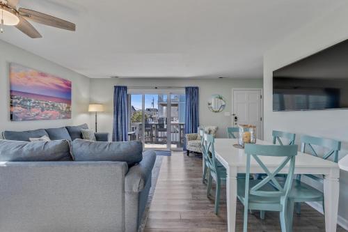 a living room with a couch and a table at The Scallop by Carolina Beach Realty in Carolina Beach