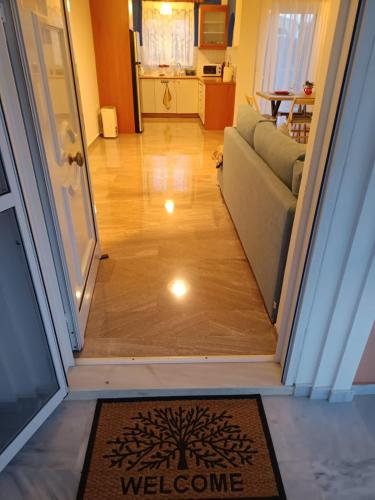a hallway with a welcome mat in front of a door at Joel Apartment in Pefkali