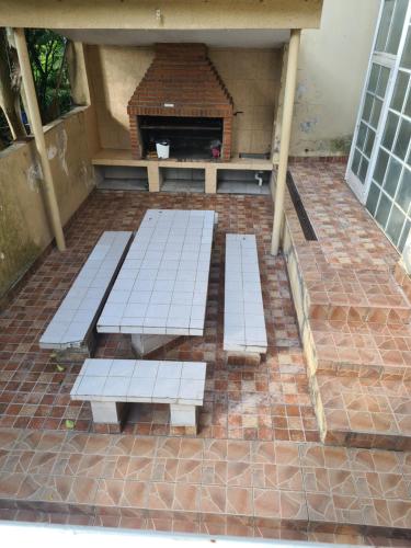 a group of benches sitting on a brick patio at Casa Al pie del Cerro in Yerba Buena
