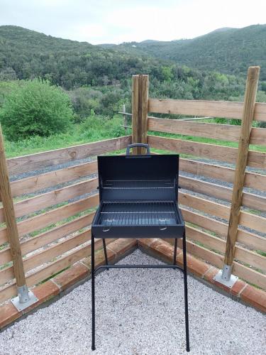 a black chair sitting on top of a fence at Apartment in Tuscan farmhouse in Livorno