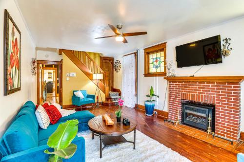 a living room with a blue couch and a fireplace at 2 Mi to Dtwn Harrisburg Escape with Furnished Deck! in Harrisburg
