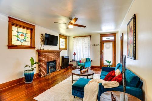 a living room with a blue couch and a fireplace at 2 Mi to Dtwn Harrisburg Escape with Furnished Deck! in Harrisburg
