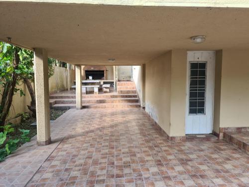 an empty porch of a house with a brick walkway at Casa Al pie del Cerro in Yerba Buena