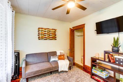 a living room with a couch and a flat screen tv at 2 Mi to Dtwn Harrisburg Escape with Furnished Deck! in Harrisburg