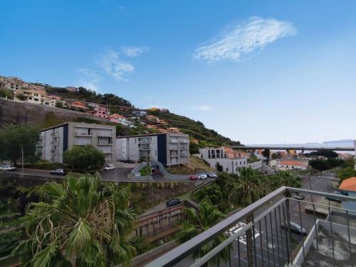 a view from a balcony of a city with a mountain at Coastal Comfort at Riverside - 4 Min to Airport! in Santa Cruz