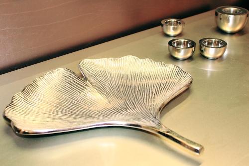 a metal spoon sitting on top of a table with cups at Milford Suites Budapest in Budapest