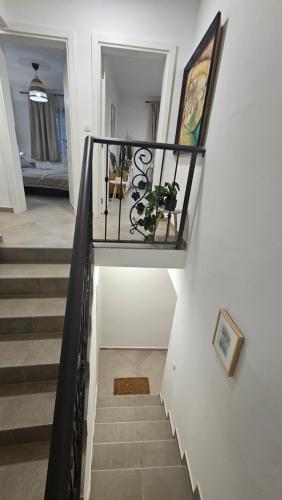 a spiral staircase in a home with a stair railing at Apartman Odigitrija Old Town in Budva