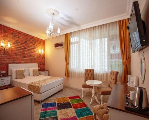 a hotel room with a bed and a tv at Ozmen Hotel Old Town Kaleiçi in Antalya