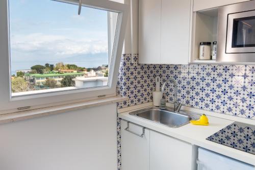 a kitchen with a sink and a window at Beauty Home Sorrento in Sorrento