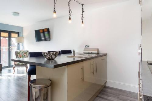 a kitchen with a counter top and a sink at Granada Apartments Berkeley in Blackpool
