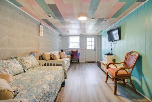 a living room with a couch and a tv at Turquoise Tunny by Carolina Beach Realty in Carolina Beach