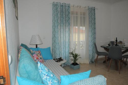 a living room with a couch and a table at Casa da Costa de Lavos in Figueira da Foz