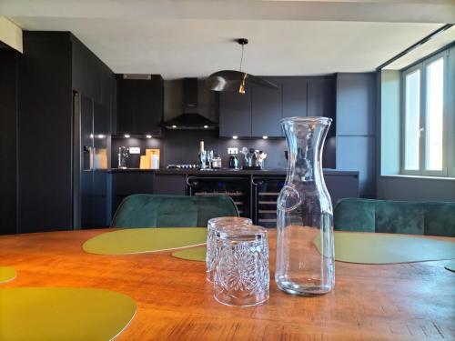 a glass vase sitting on top of a wooden table at La seigneurie de Godefroy in Bouillon
