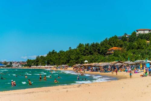 a group of people in the water at a beach at P & K Design LTD Flats in Nea Moudania
