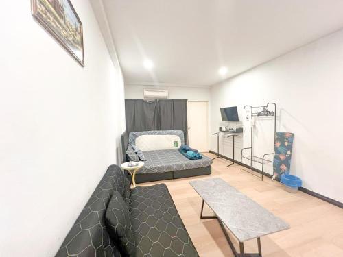 a living room with a couch and a table at KK City Api Api Block 1 Above Mcd Studio Homestay 2-3 pax in Kota Kinabalu