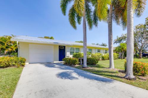 a house with palm trees and a driveway at Swim, Golf and Explore Family-Friendly Stuart Gem in Stuart