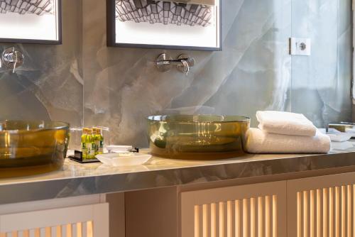a bathroom counter with two bowls on a sink at Bellevue San Lorenzo (Adults Only) in Malcesine