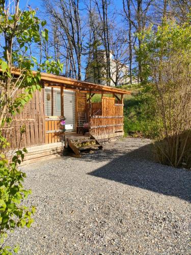 a cabin in the woods with a gravel yard at Camping du Moulin de Thoard in Thoard