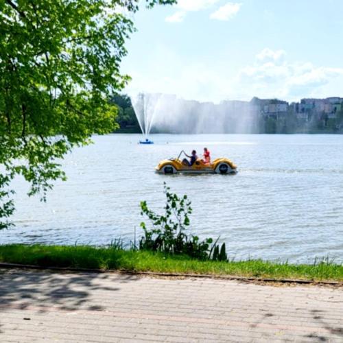 two people on a boat in a lake at Mieszkanie Starówka Centrum Iława in Iława