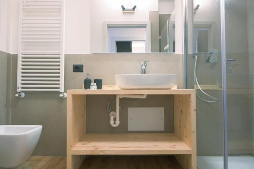 a bathroom with a sink and a shower at Costa blu - terrace overlooking the lake & pool in Riva di Solto