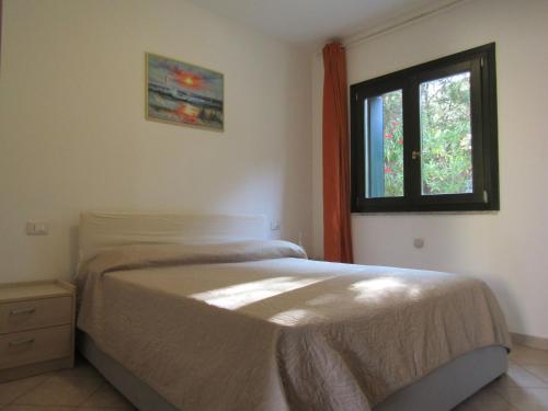 Ένα ή περισσότερα κρεβάτια σε δωμάτιο στο Casa in Residence con Piscina a 10 Minuti dal Mare
