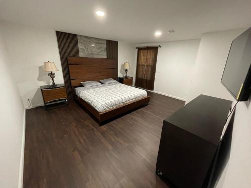 a bedroom with a bed and a tv in it at Cozy 2 BR Apartment Glendale in Glendale