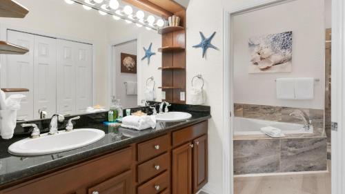 a bathroom with two sinks and a tub at 801 Mariners Club in Key Largo