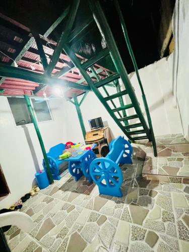 a room with some blue chairs and a table at Hadiqah event venue in Mangangpico