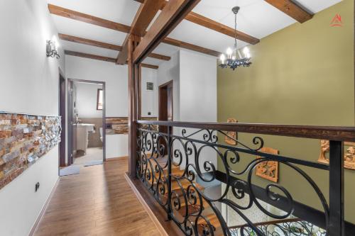 a staircase with a wrought iron railing in a house at Luca Residence Beautiful Villa in Trăisteni