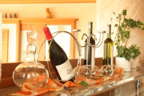 a counter with two bottles and two glasses of wine at Landhotel Bärnriegel in Mauth