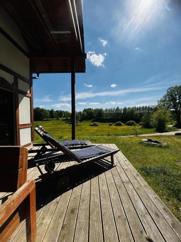 a deck with a lounger on top of a house at Domek A 156 Na Zakręcie- Kaszubska Ostoja in Barkocin