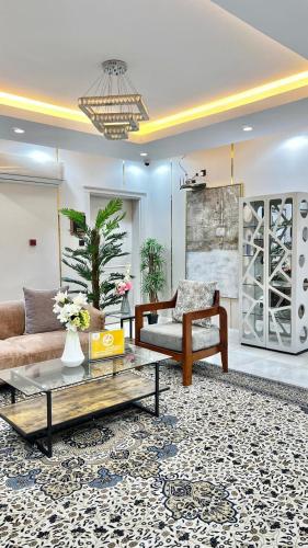 a living room with a couch and a coffee table at حلو الأماكن للشقق المخدومة-إقتصادي in Bisha