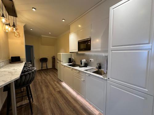 a kitchen with a white refrigerator and a counter at Haus der Weine in Rüdesheim am Rhein