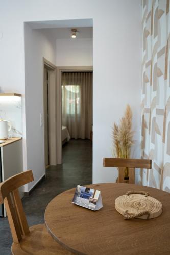 a dining room table with a book on top of it at Heleon Luxury Apartments in Parga