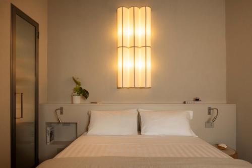 a bedroom with a bed with two white pillows at Velvet Grey Boutique Hotel Roma in Rome
