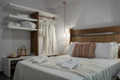 a bedroom with a bed with towels on it at Heleon Luxury Apartments in Parga
