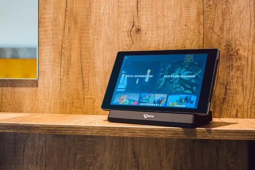 a laptop computer sitting on top of a wooden table at Euston Square Hotel in London